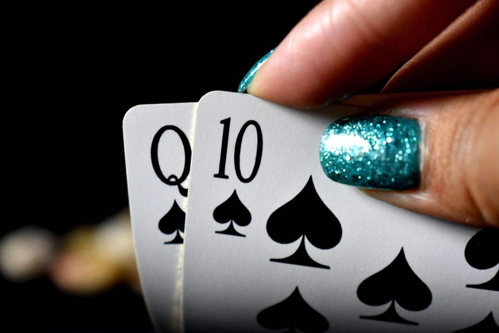 Fingers holding poker cards