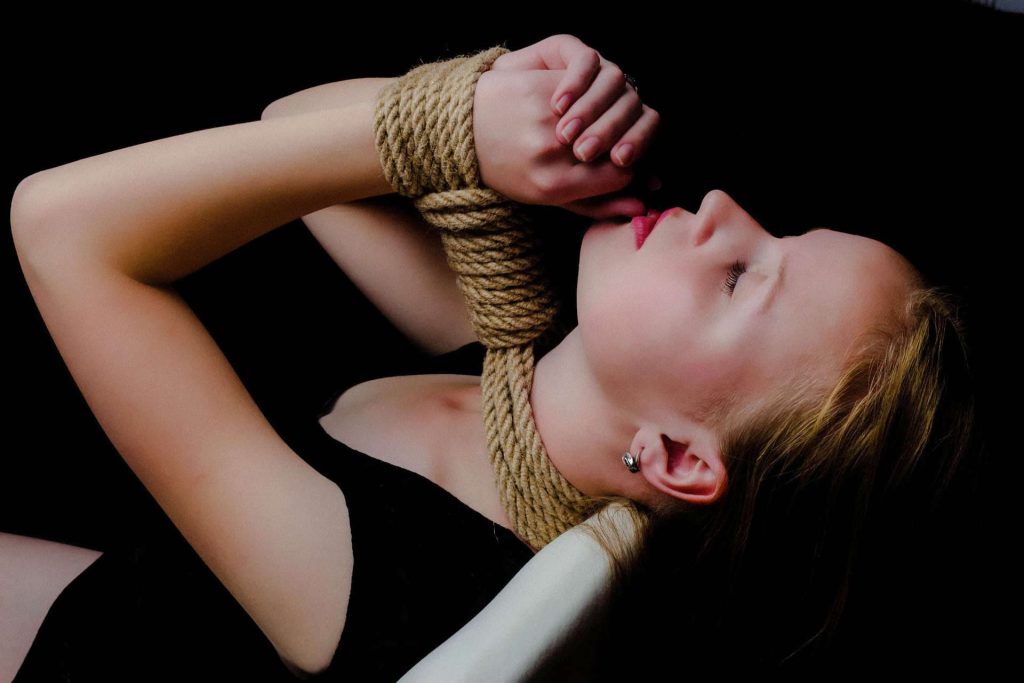 Woman with rope bondage around neck